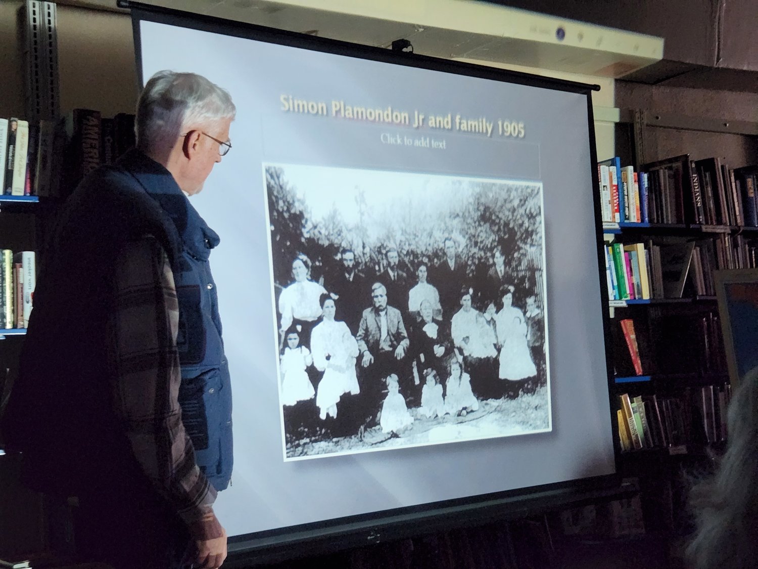 Robert Foxcurran shows a photo of Simon Plamondon Jr.’s family during a recent presentation in Toledo.